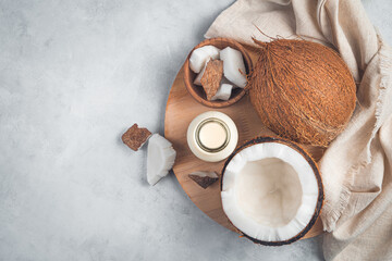 Coconuts and coconut milk on a wooden board on a gray background. - obrazy, fototapety, plakaty