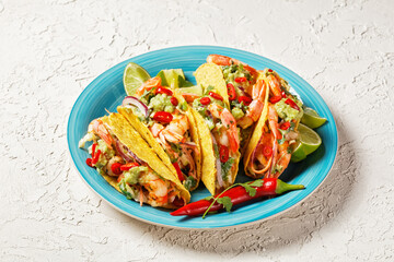 taco shells with shrimps on a plate