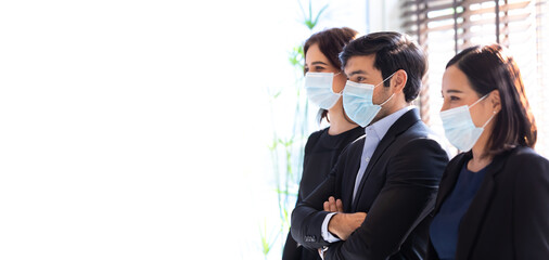 Attractive businesswoman and man manager are colleagues working on laptop computer together in office. face mask prevent covid-19 virus