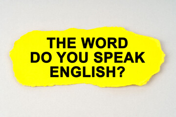 On a white background lies yellow paper with the inscription - THE WORD DO YOU SPEAK ENGLISH
