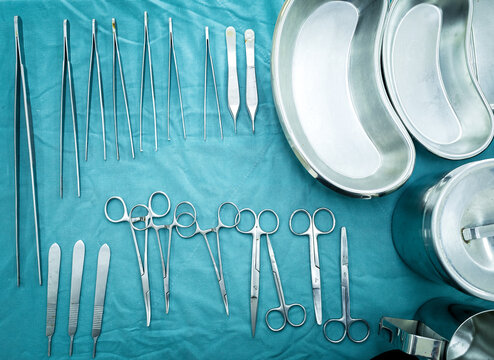 Different surgical instruments lying on the surgical table. Steel medical instruments ready to be used.