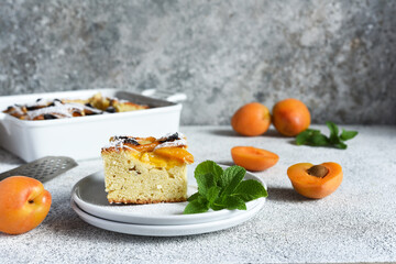 cake with apricots. Homemade pie with peaches and apricots on the kitchen table.