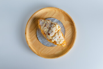 Delicious croissants and coffee cup on wooden plate. Freshly baked.