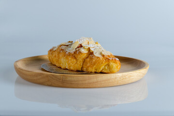 Delicious croissants and coffee cup on wooden plate. Freshly baked.