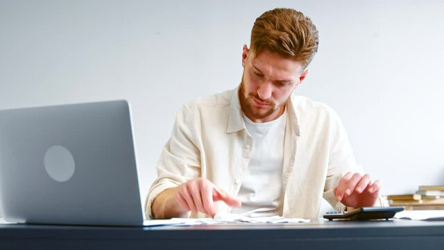 Skilled accountant looks at paper checks and summaries