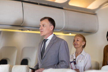 Senior business man passenger sitting in comfortable business class seat