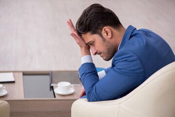 Young male employee waiting for business meeting