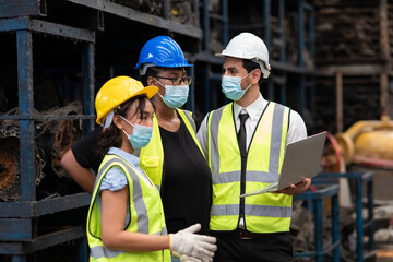 Engineer factory people wearing protective face mask prevent covid-19 virus. Professional Mechanical Engineer team Working at Second-hand spare parts of old car parts warehouse store.