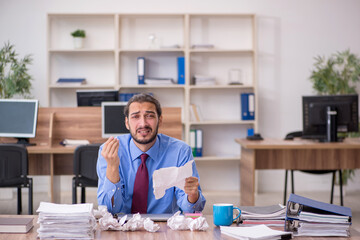 Young male employee in brainstorming concept