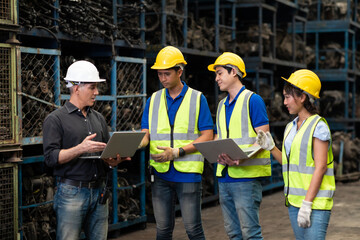 Professional Mechanical Engineer team Working on Personal Computer at Second-hand spare parts of old car parts warehouse store.