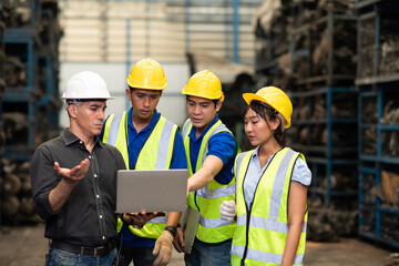Professional Mechanical Engineer team Working on Personal Computer at Second-hand spare parts of old car parts warehouse store.