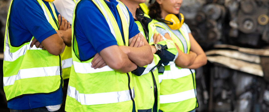 Unity and teamwork concept. team standing hands together. Professional Mechanical Engineer team Working at Second-hand spare parts of old car parts warehouse store. High five.