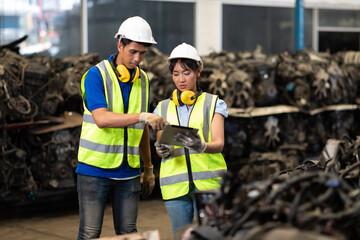 Warehouse managers and worker asian team working and discussing with desktop computer at large distribution warehouse.