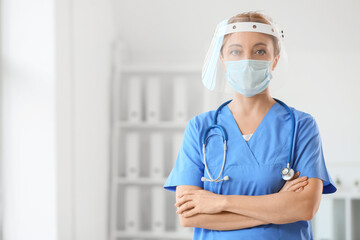 Portrait of female doctor with protective uniform in clinic