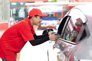 young man driver payment by credit card on gas station. Power to drive vehicles and gas station...