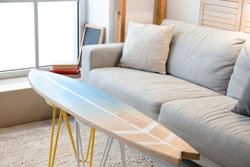 Interior of modern stylish room with surfboard and sofa