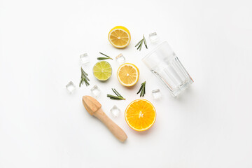Composition with glass and healthy citrus fruits on white background