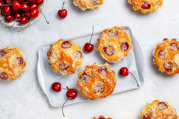 Homemade muffins with sweet red cherries.