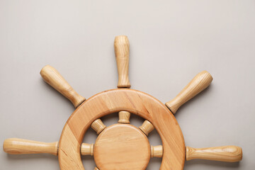 Ship helm on grey background