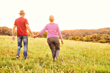 woman man outdoor senior couple happy lifestyle retirement together smiling love old nature mature back view walking future hope happy holding hands