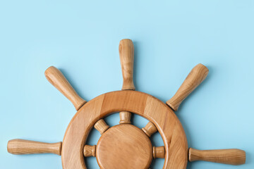 Ship helm on color background