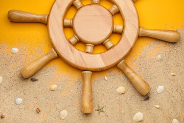 Helm, sand and sea shells on color background