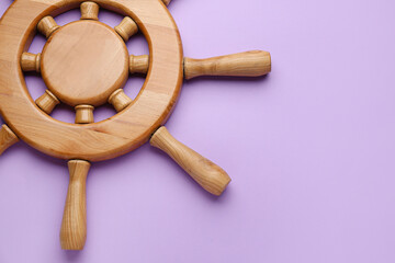 Ship helm on color background