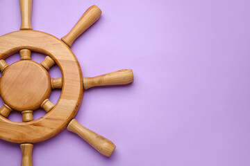 Ship helm on color background