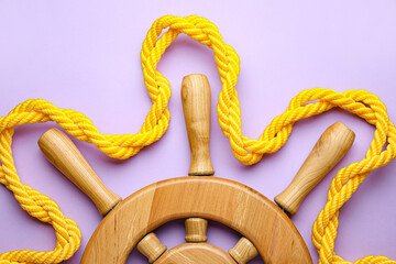 Helm and rope on color background