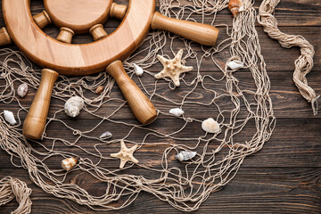 Helm, net and sea shells on wooden background