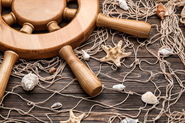 Helm, net and sea shells on wooden background