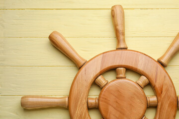 Ship helm on wooden background