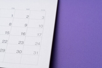 close up of calendar on the purple table background, planning for business meeting or travel planning concept