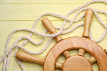 Helm and rope on wooden background