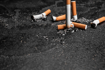 Burnt cigarettes on dark background