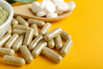 Many pills on color background, closeup