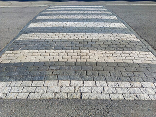 pedestrian zebra crossing with nice 
paving stones and white paint