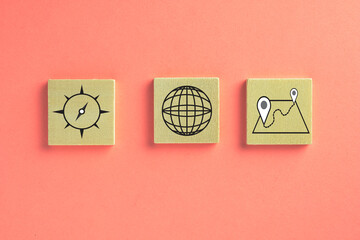 Travel icon on wooden cube over pink pastel background use for travel,holiday concept with copyspace.