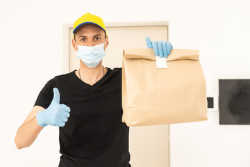 Fototapeta na wymiar delivery man in protective gloves and a mask