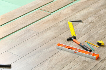 New laminate flooring with tools in room