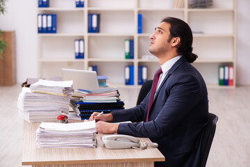 Young male employee unhappy with excessive work