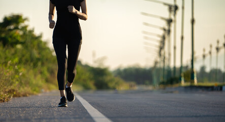 Young woman runner running on city bridge road, Young fitness woman runner athlete running at road
