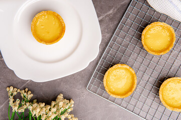 The egg tart  is a kind of custard tart found in Cantonese cuisine derived from the English custard tart and Portuguese pastel de nata. Egg tarts are often served at dim sum restaurants and cha chaan 
