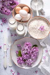 Obraz na płótnie Canvas Ingredients for fried lilac flower in pancake dough. Summer dessert.