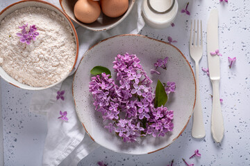 Homemade fried lilac flower in pancake dough. Sweet snack.