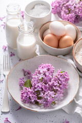 Obraz na płótnie Canvas Homemade fried lilac flower with powdered sugar. Sweet snack.