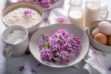 Obraz na płótnie Canvas Preparation for fried lilac flower with powdered sugar. Sweet snack.