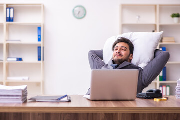 Young male employee in oversleeping concept