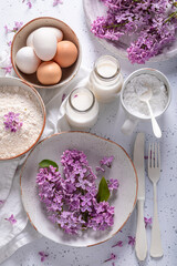 Obraz na płótnie Canvas Tasty fried lilac flower with powdered sugar. Summer dessert.