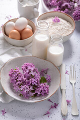 Preparation for fried lilac flower with powdered sugar. Summer dessert.